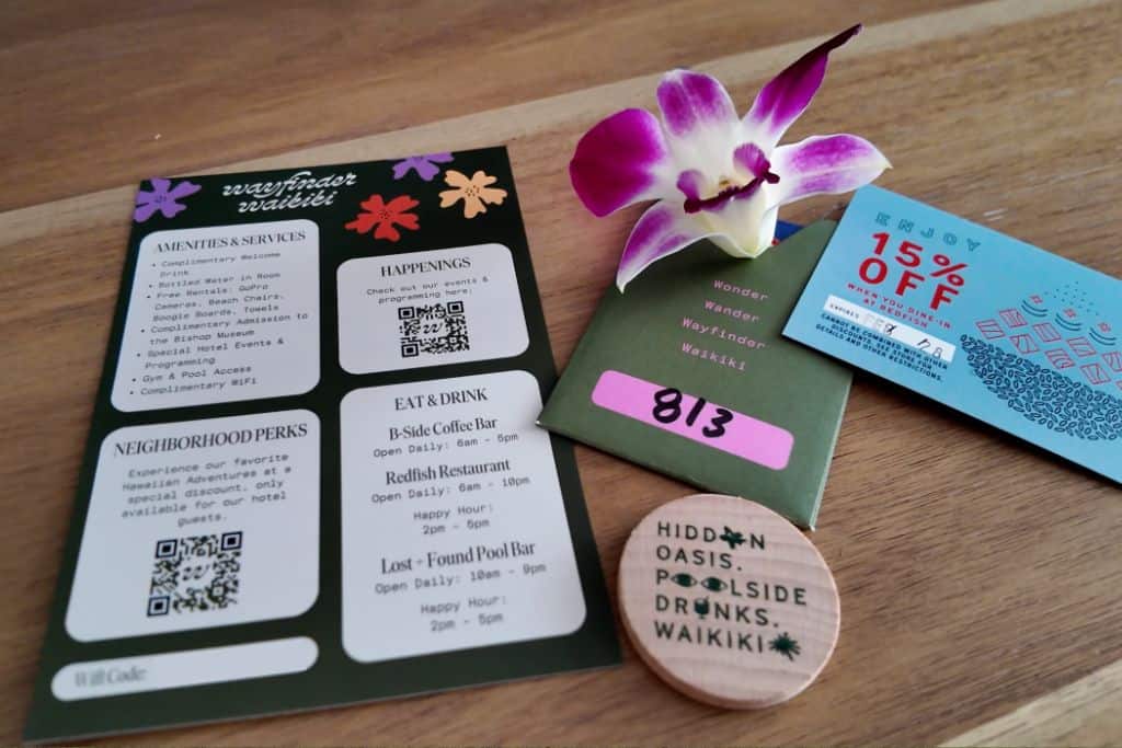 Hotel information card, drink token, room 813 card and orchid flower