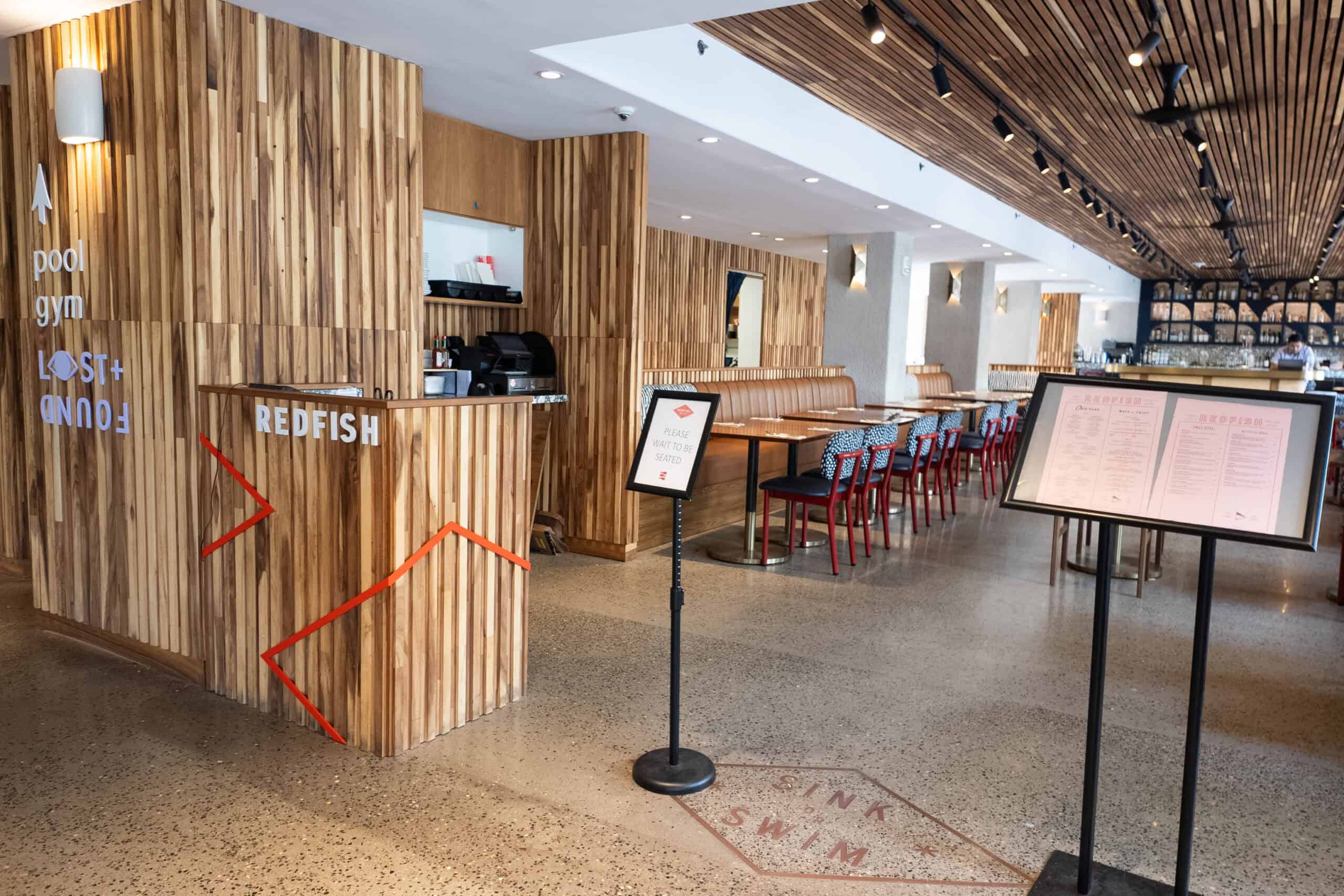 A wooden restaurant with a sign that says Redfish