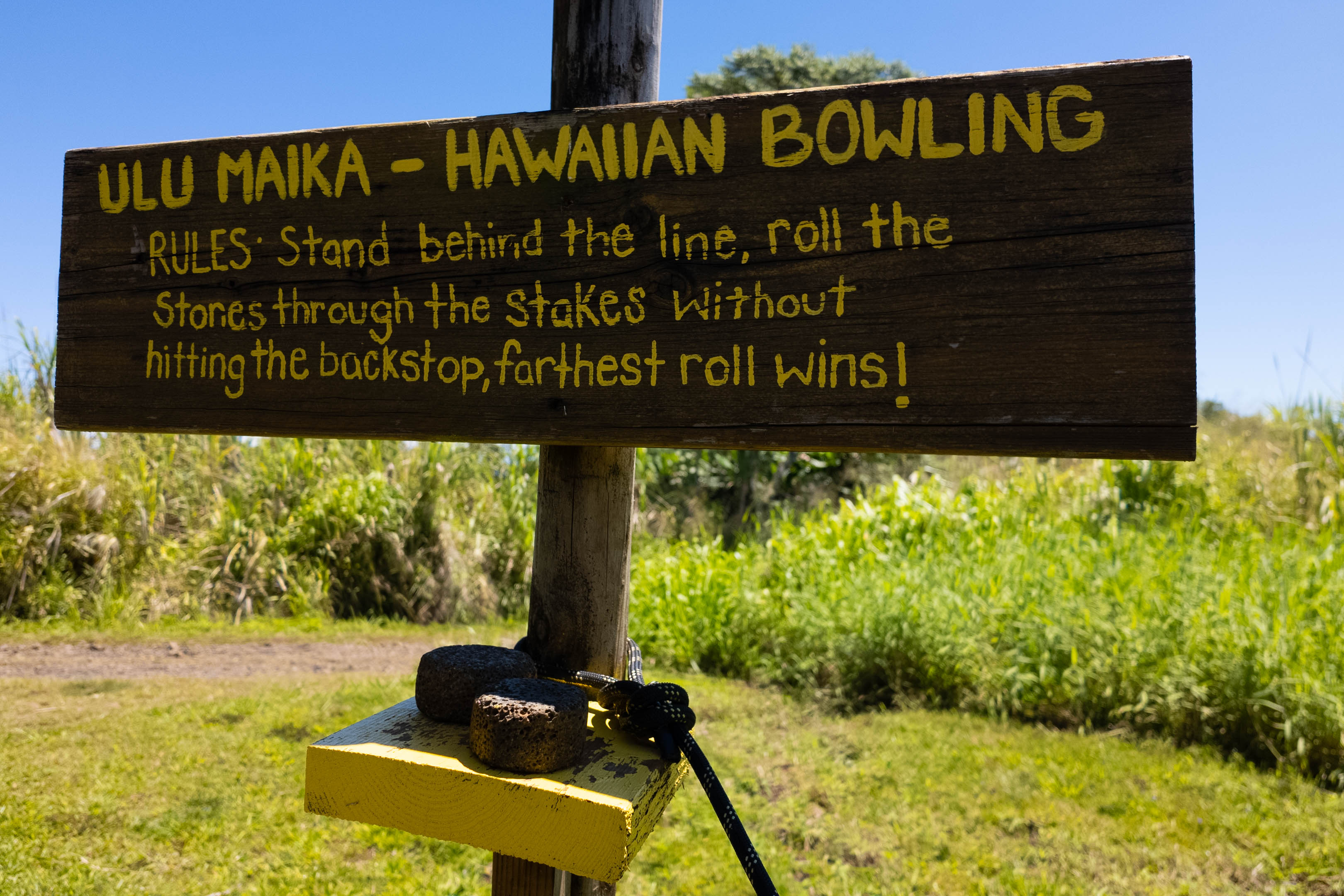 A wooden sign that says Hawaiian Bowling