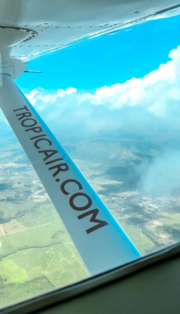 tropical-view-of-belize-palm-trees-and-clouds-from-puddle-jumper-airplane-makes-getting-around-belize-simple