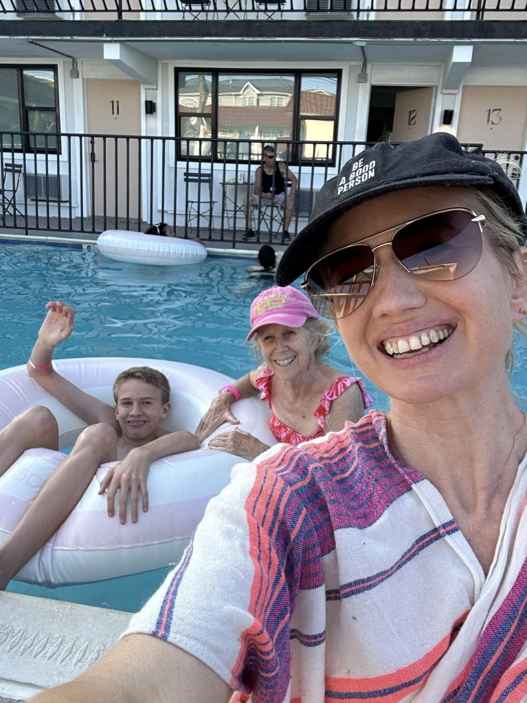 Two women and a teen in pool floats in a hotel pool